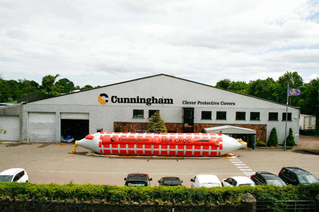 Cunningham's Sea Croc Towable Bladder in front of Factory