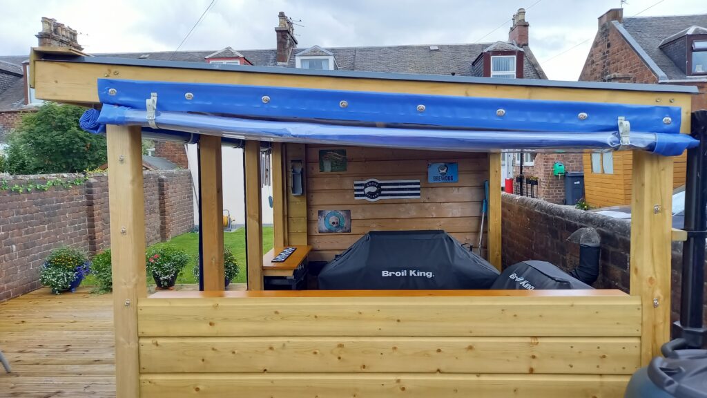 Blue PVC Side Panel Window Rolled Up on Wooden Garden Shed